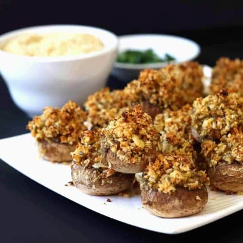 Stuffed Mushrooms plated with ingredients behind.