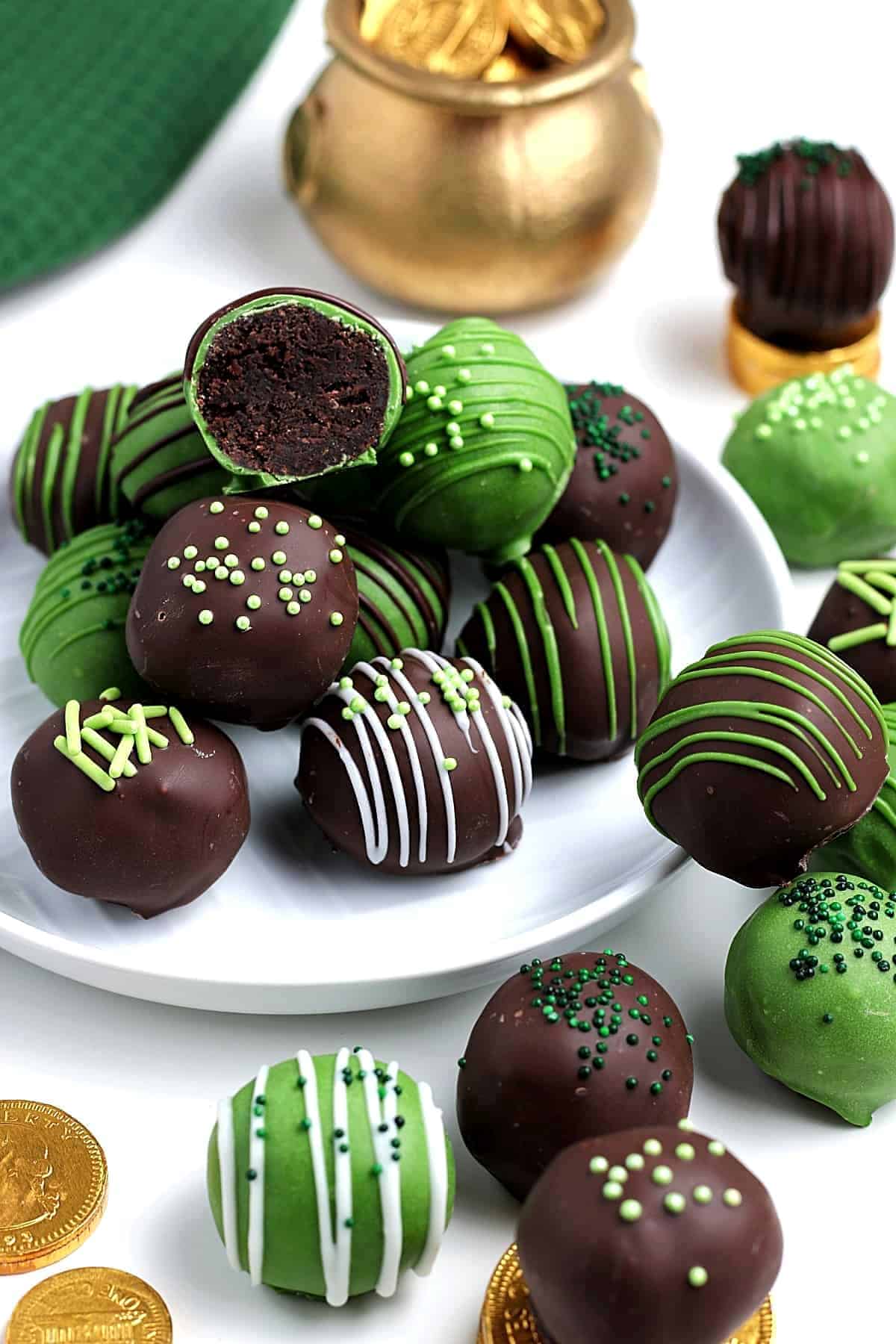 Piles of chocolate and green candy treats decorated for St. Patrick's day.