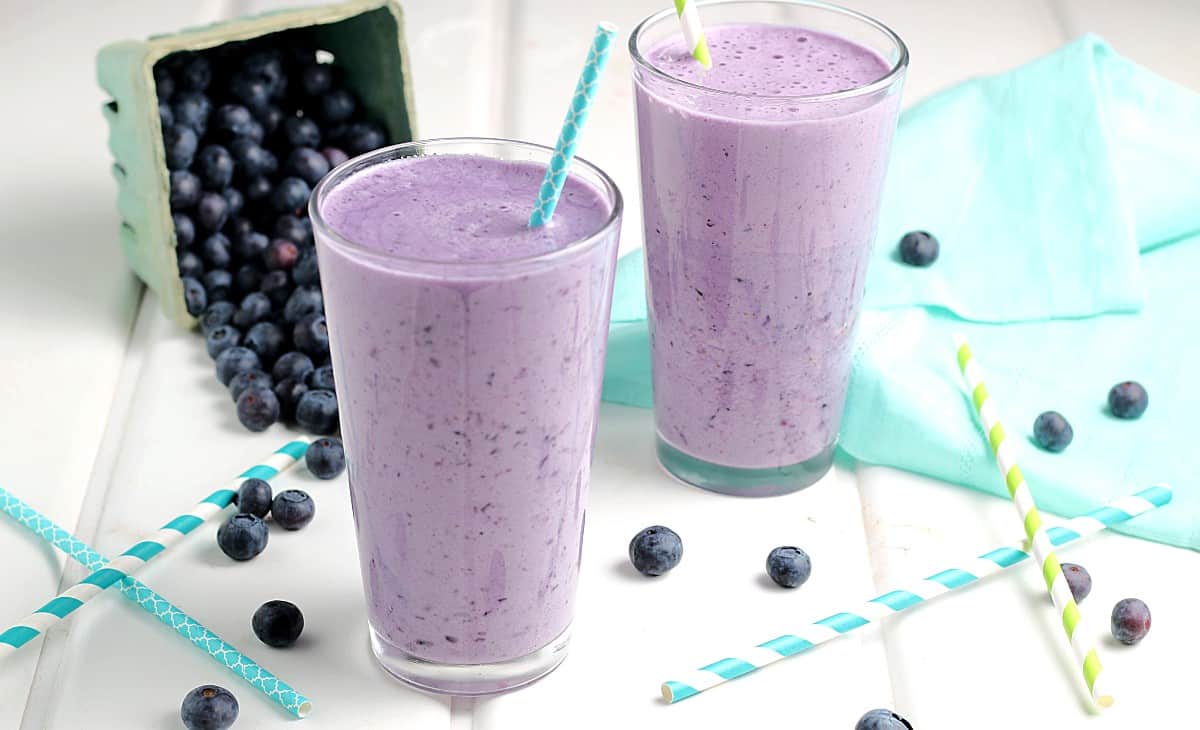Two glasses filled with blueberry shake.