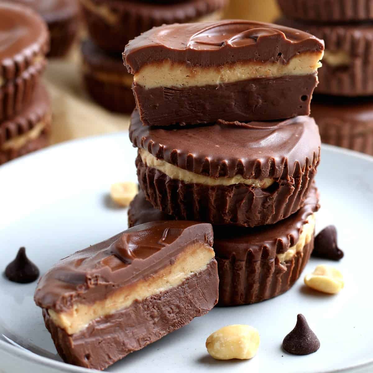 Stack of three vegan peanut butter cups with the top one cut open.