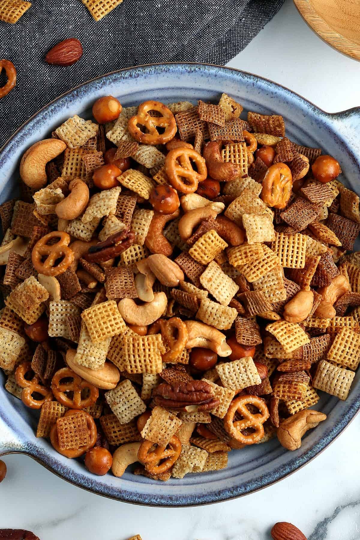 Overhead pgoto of a large pottery serving bowl filled with party mix.