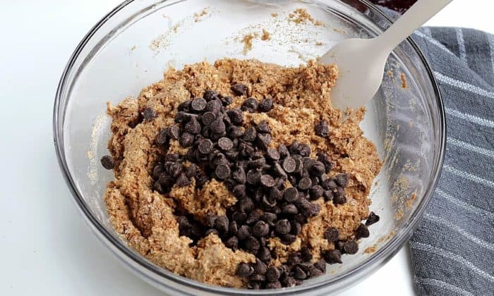 Muffins batter with chocolate chips poured on top.