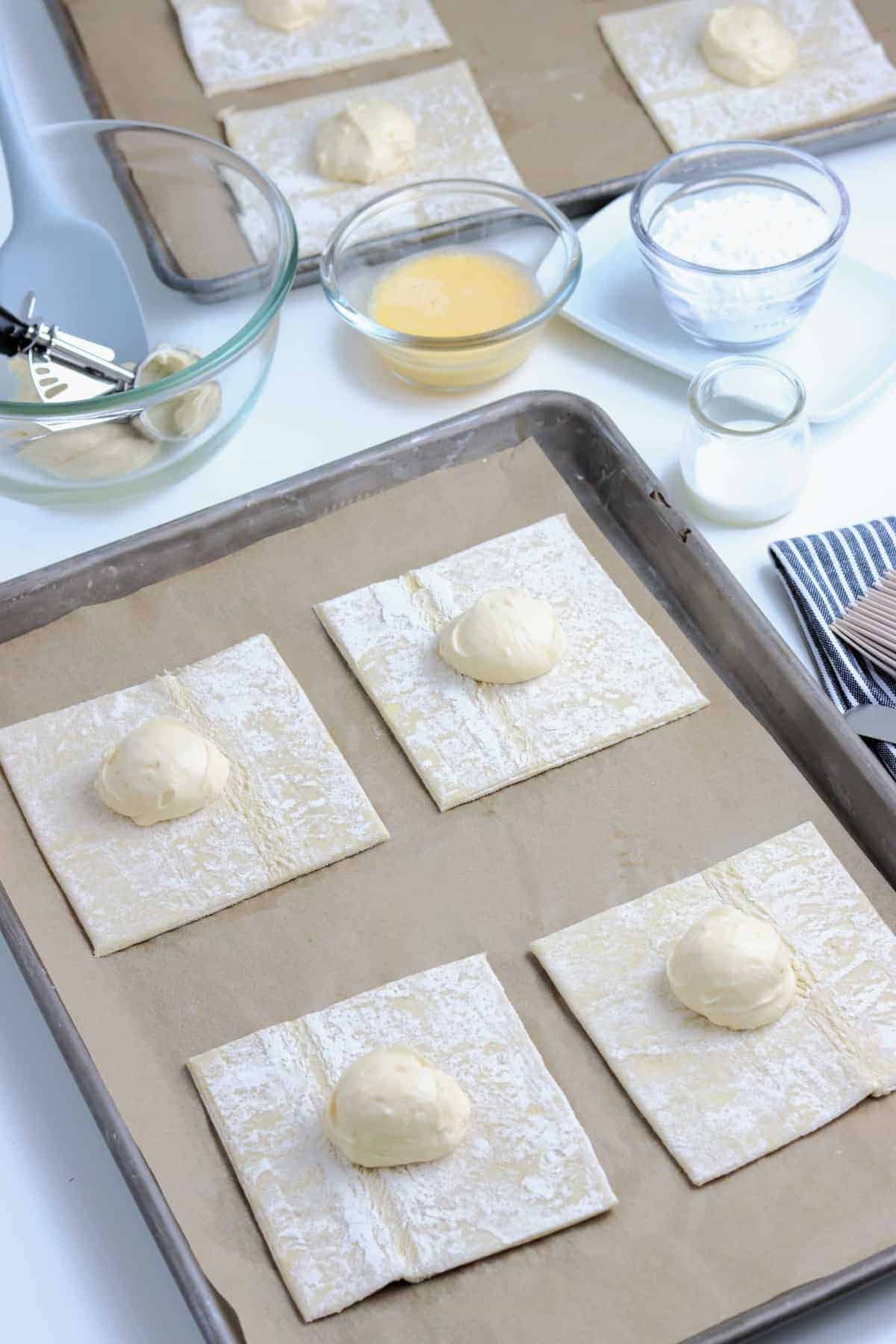 Puff pastry squares with a dollop of the filling in the centers of each.