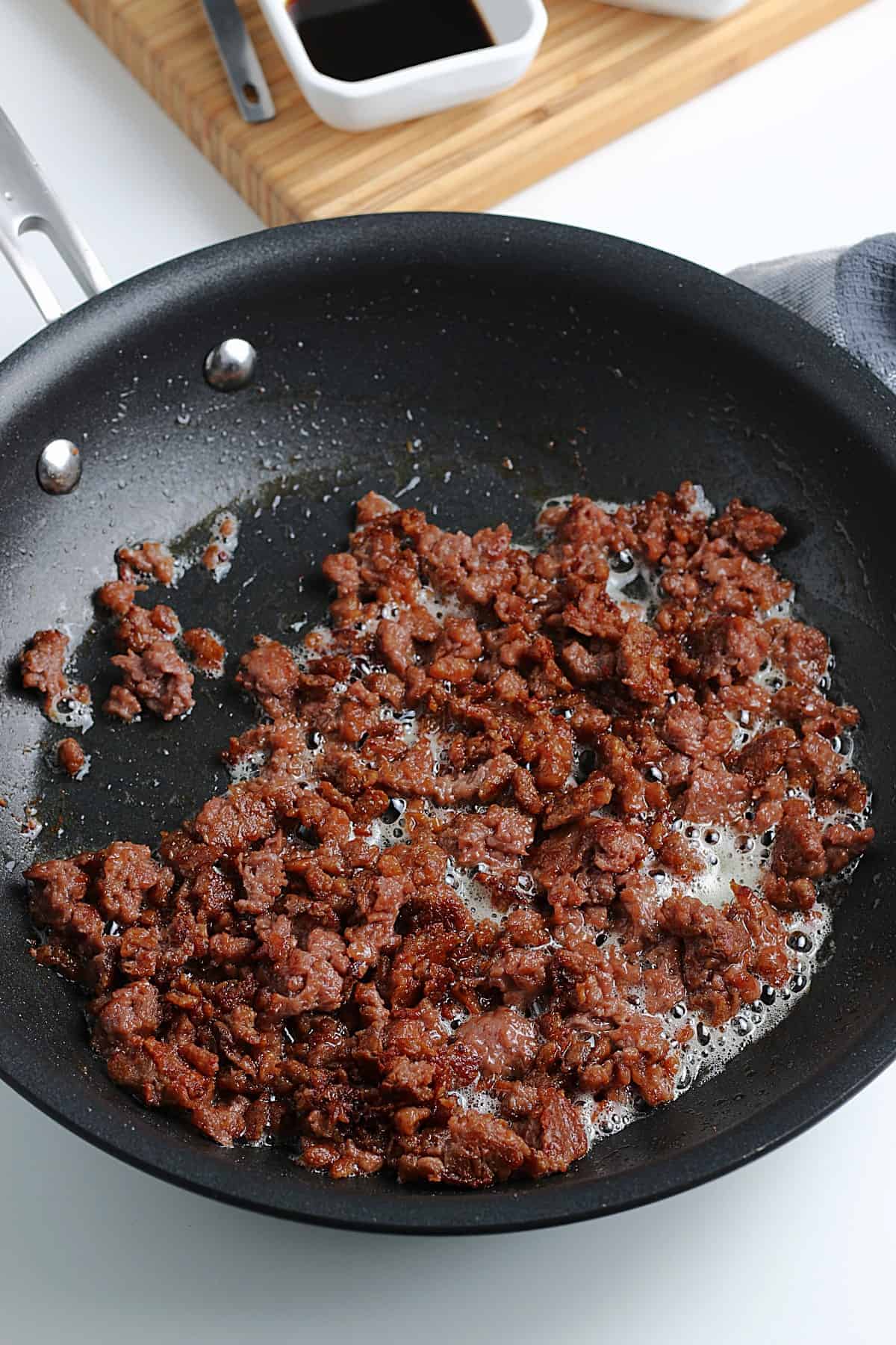 Browning plant based meat in a skillet.