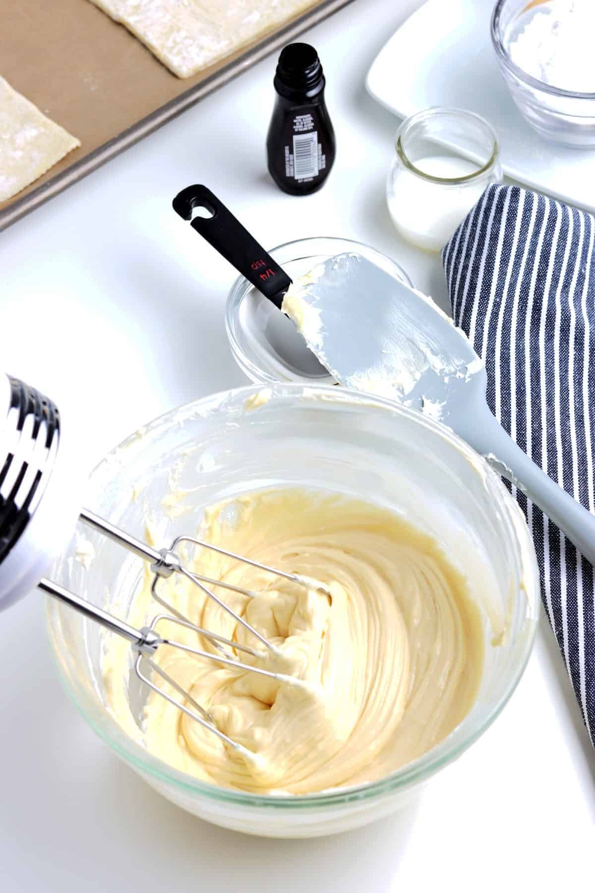 Cream cheese in a bowl with other ingredients and whipped smooth.