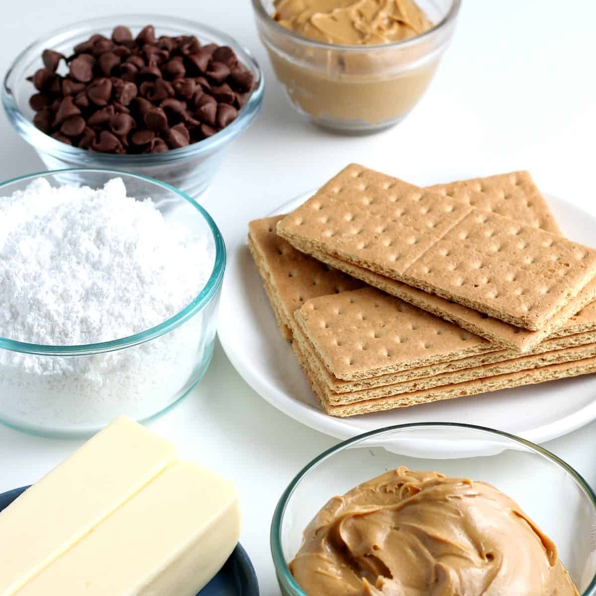 Five ingredients i separate bowls for chocolate peanut butter bars.