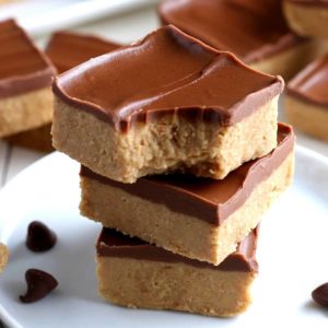 Three stacks of no bake vegan squares on a white plate.