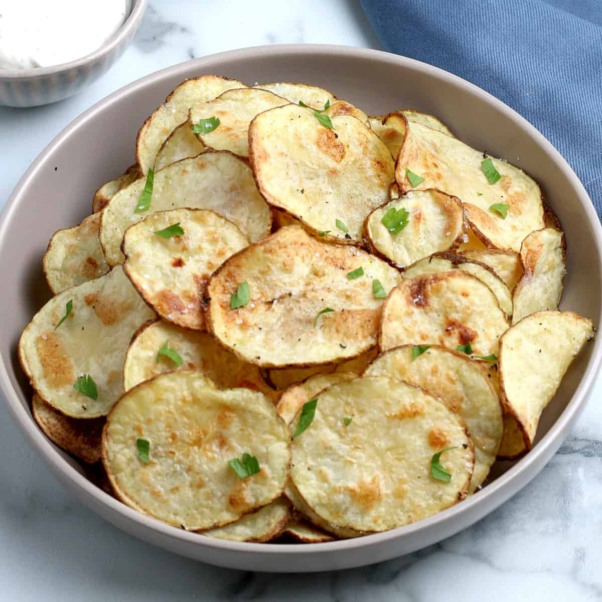 Tilted bowl filled with fried vegetable snacks.