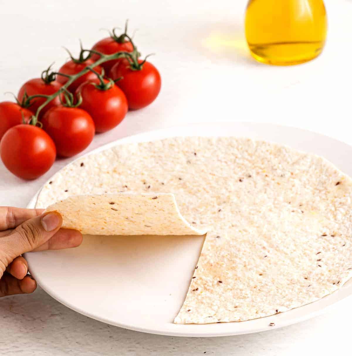 Showing the tortilla cut in preparation for folding your lunch.