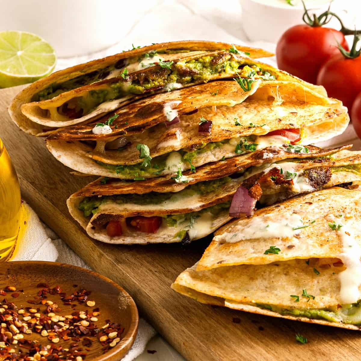 Front view of cooked and quesadillas that are stacked on top of each other.