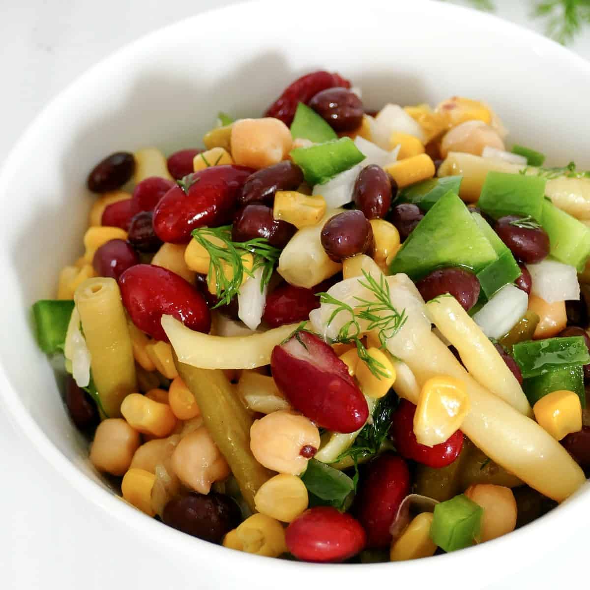 Close up square photo of a mixed 5 bean salad.