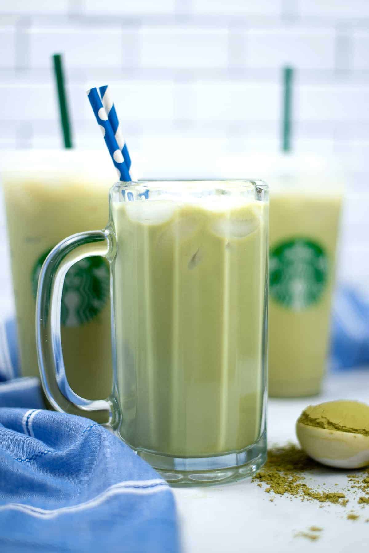 Glass handles mug filled with ice and green tea.