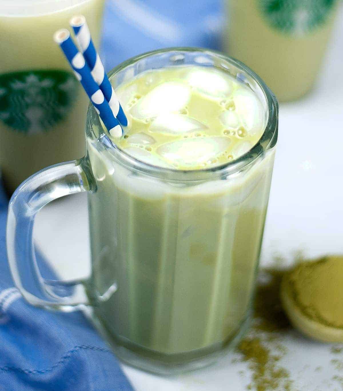 Tilted glass mug filled with an icred green drink.