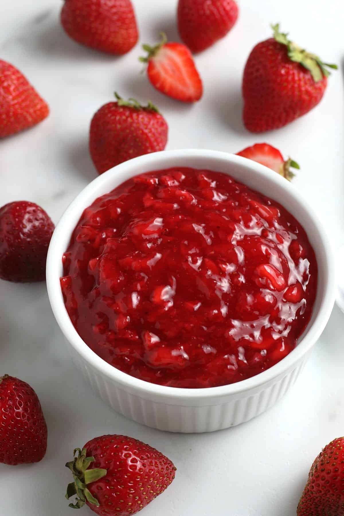 Overhead view of a bowlful of fruit preserves.