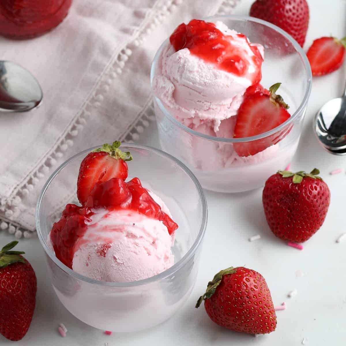 Strawberry dairy free ice cream is topped with fruit topping.