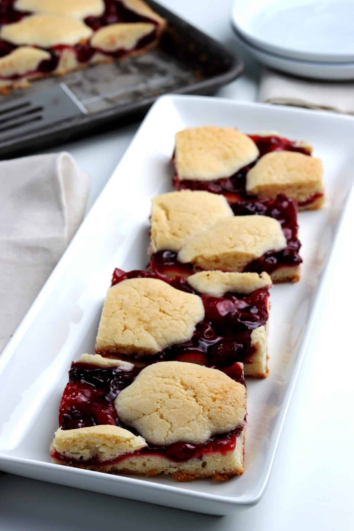Serving tray lined up with cherry pie bars.