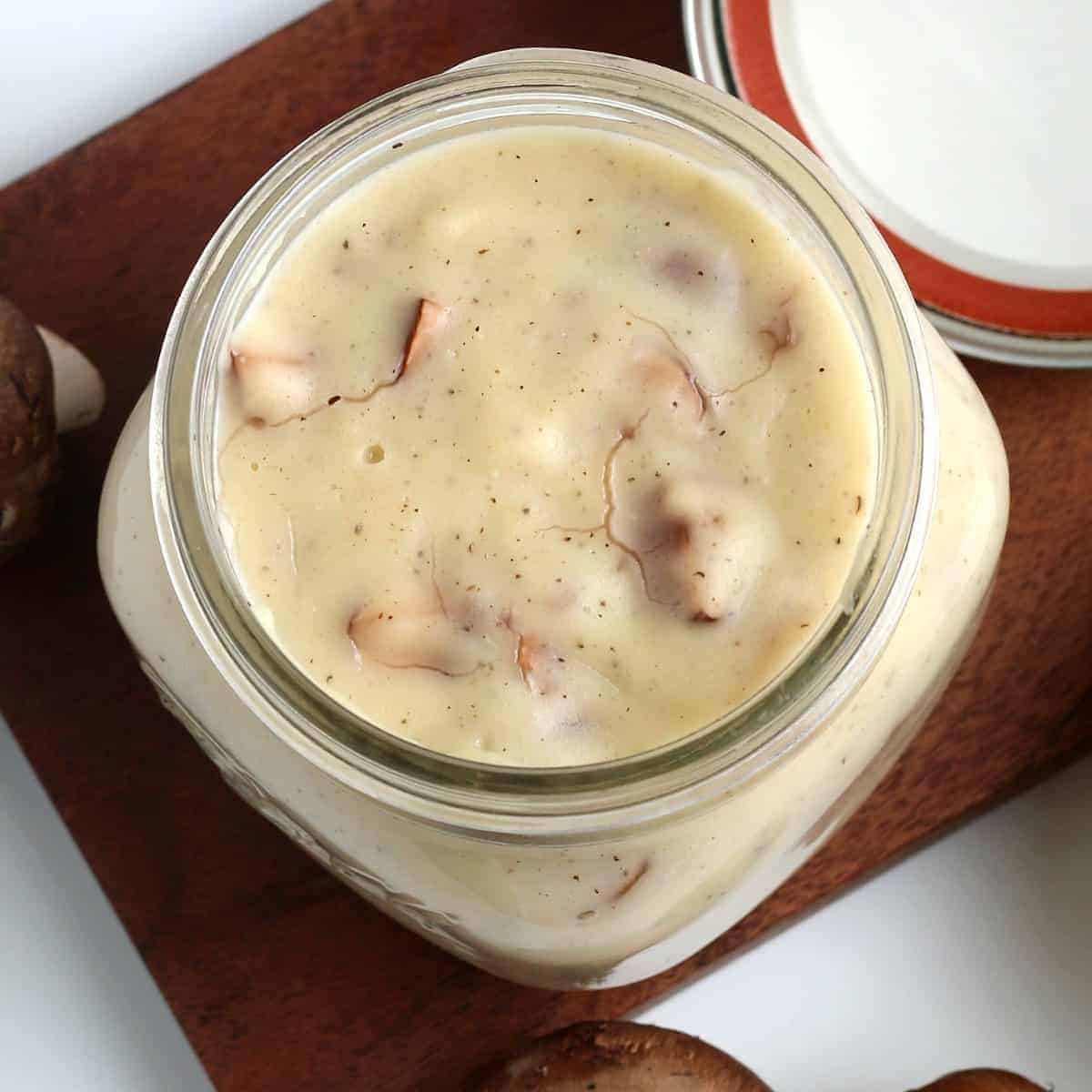 Overhead view of cream of mushroom soup in a jar.