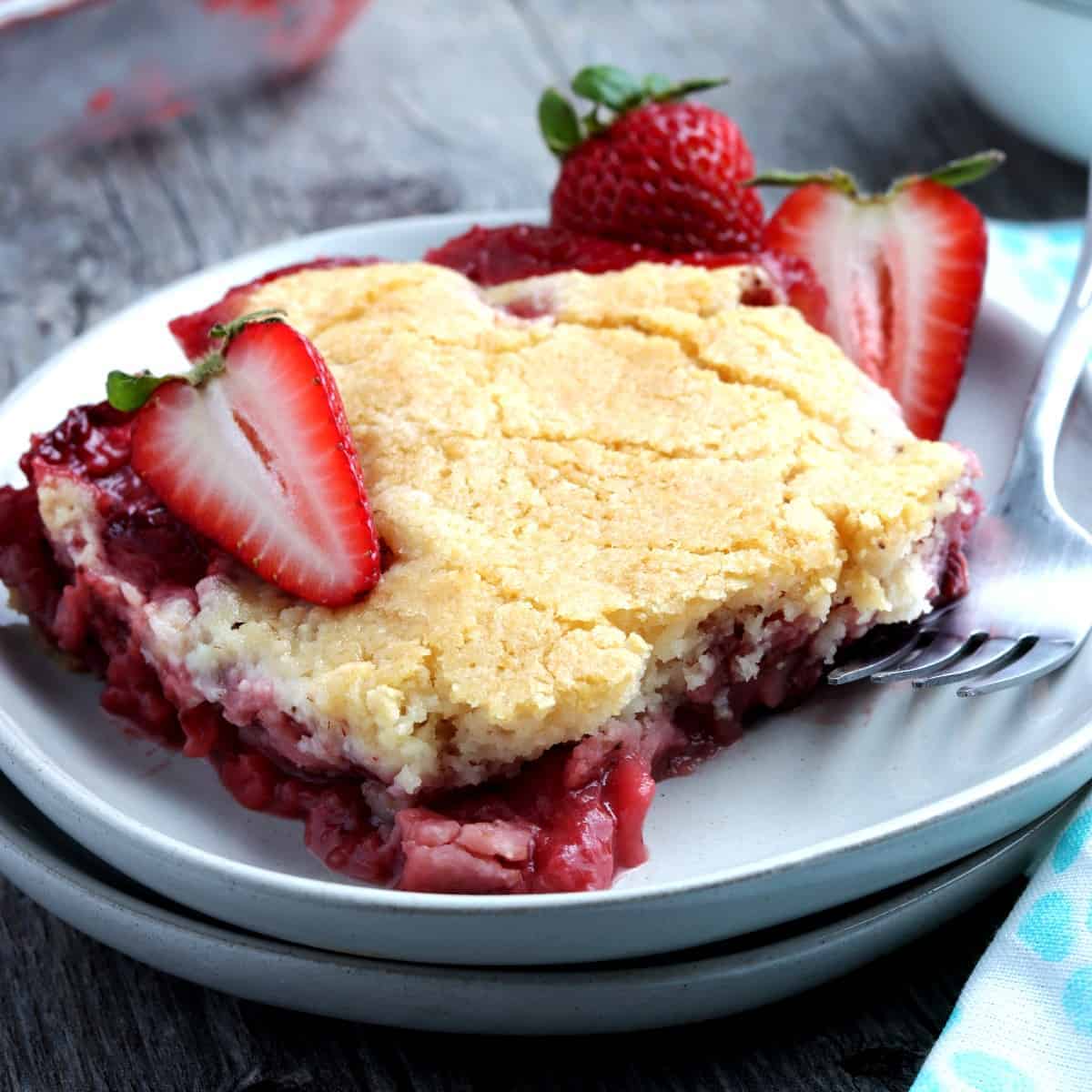 One generous square piece of strawberry cobbler on a serving plate.