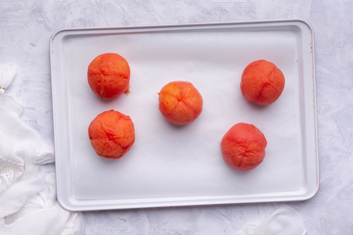 Place peeled tomatoes on baking sheet