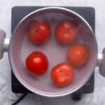 Add tomatoes to simmering water