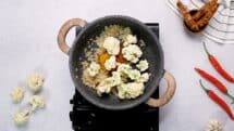 Add garam masala cumin turmeric cayenne pepper and 2 cups cauliflower florets to the pot