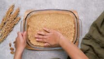 Press down with your fingers to an even layer all across the pan bottom