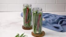 Slip two chili peppers down in between the green beans in each jar