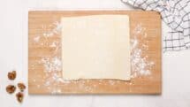 Lightly flour a surface and open up the puff pastry sheet