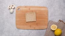 Cut crusts off of the bread and leave in a square shape