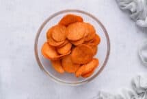 Toss in a bowl with the oil so that each sweet potato slice is lightly coated