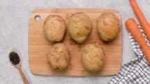Scrub the potatoes clean and poke them with a knife