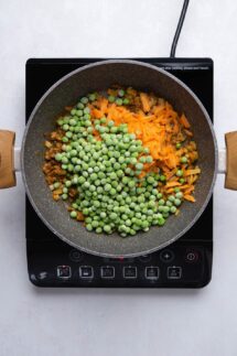 Add the peas and carrots to the pan and mix well