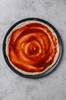 Spread the BBQ sauce over the pizza dough