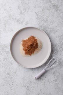 combine cane sugar and cinnamon on a wide and shallow plate