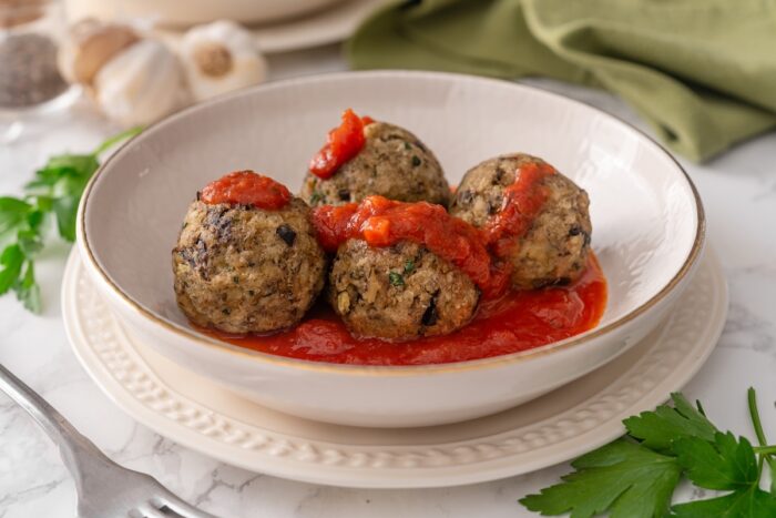 eggplant meatballs are dolloped with fresh marinara sauce to serve